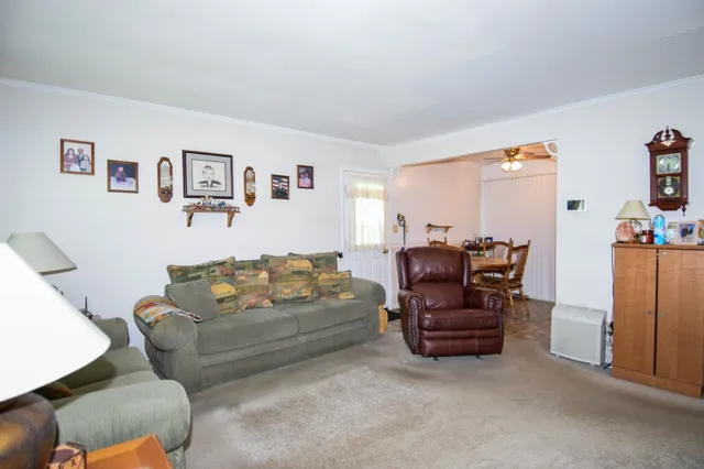 a living room with furniture and a piano