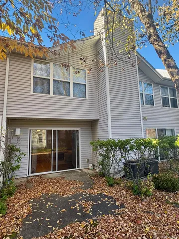 a view of a brick house with a large windows and plants