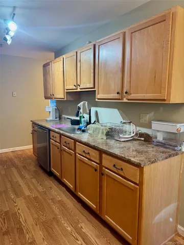 a kitchen with stainless steel appliances granite countertop a sink a stove cabinets and a counter top space