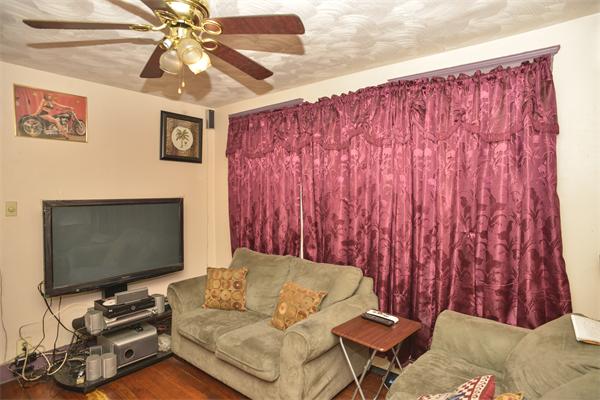 23 Crowell Street Boston, MA 02124 - Photo 3 of 11 a living room with furniture and a flat screen tv