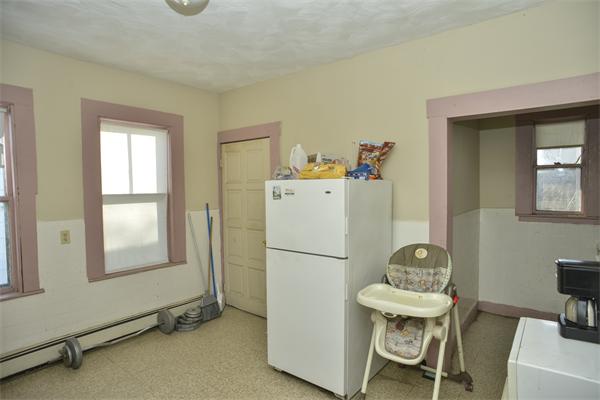 23 Crowell Street Boston, MA 02124 - Photo 4 of 11 a white room with a table and chairs