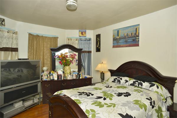 23 Crowell Street Boston, MA 02124 - Photo 5 of 11 a bedroom with a bed and dresser