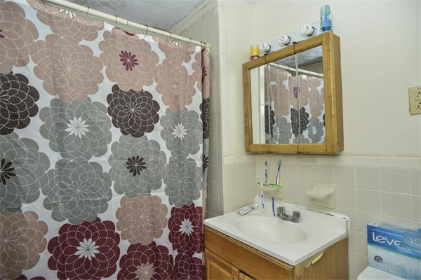 23 Crowell Street Boston, MA 02124 - Photo 6 of 11 a bathroom with a sink mirror and vanity