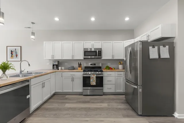 a kitchen with a sink stainless steel appliances and cabinets