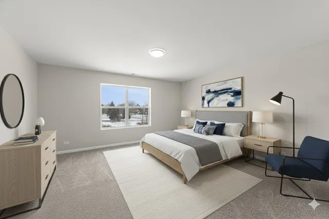 a spacious bedroom with a bed a table and painting on the wall