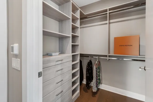 a view of walk in closet with empty racks