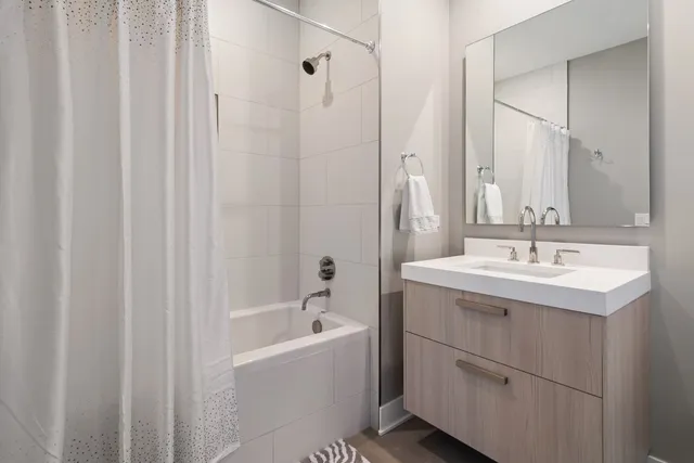 a bathroom with a sink a mirror and a bathtub