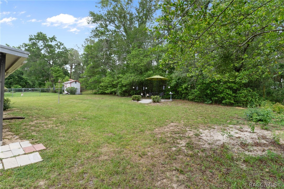 3355 South Highlands Avenue Inverness, FL 34452 - Photo 27 of 30 a view of a green field with trees in the background