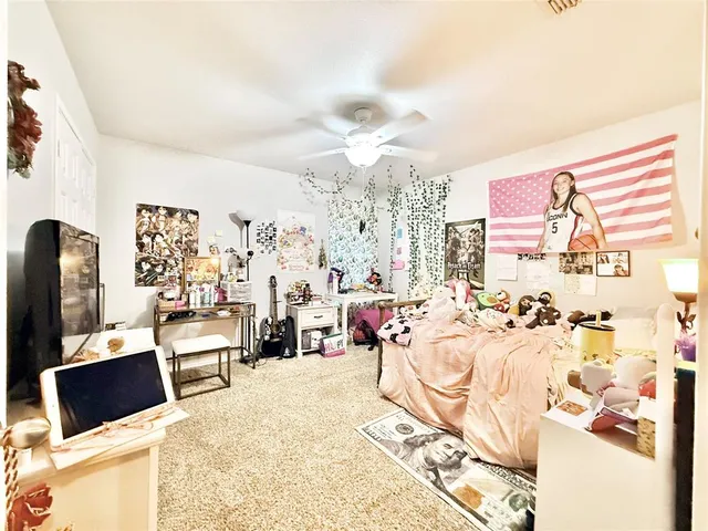 a living room with furniture a chandelier and a large window