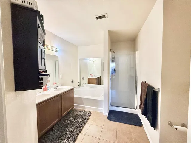 a bathroom with a sink a mirror and a shower