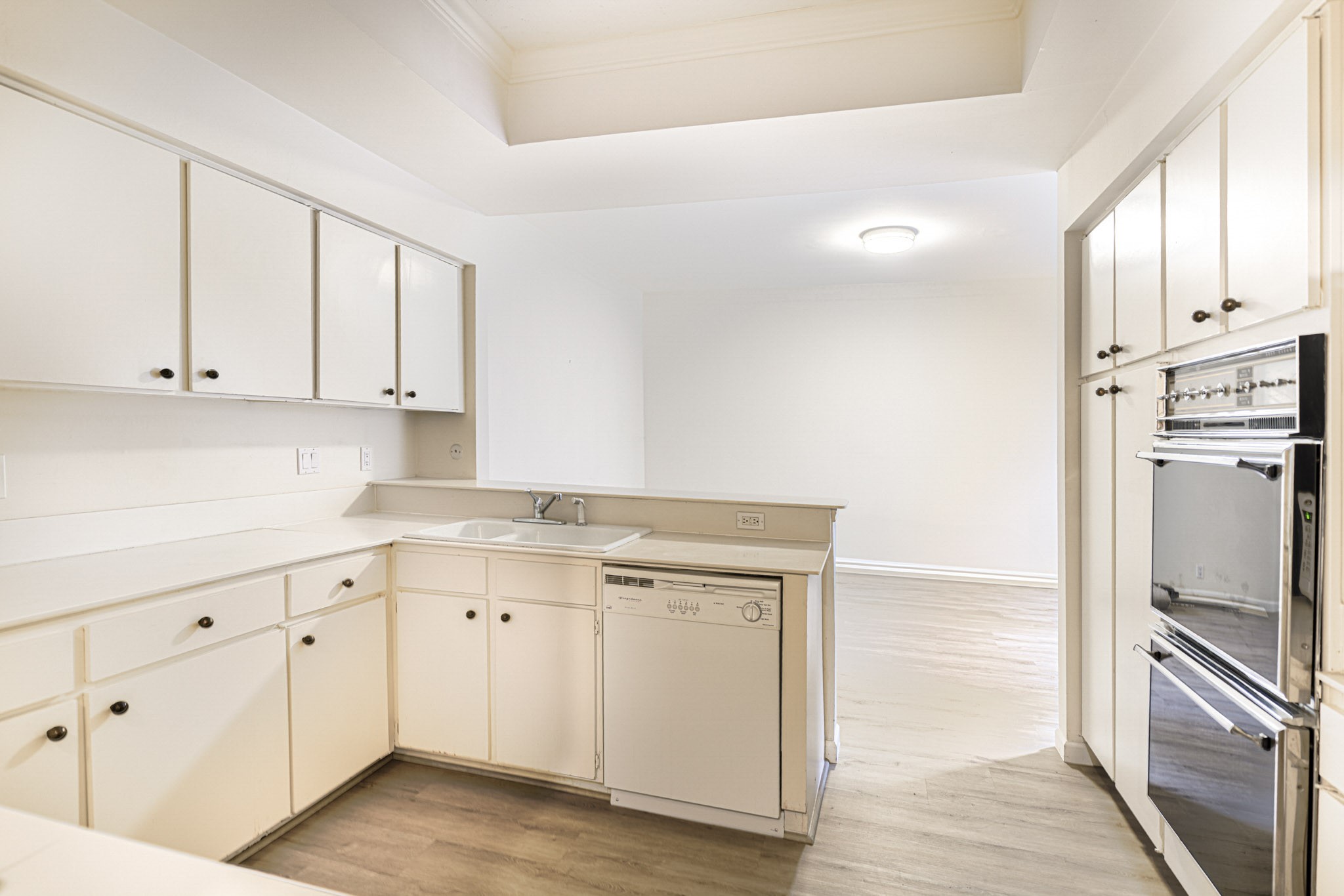152 Litchfield Lane Houston, TX 77024 - Photo 12 of 33 a kitchen with white cabinets and stainless steel appliances