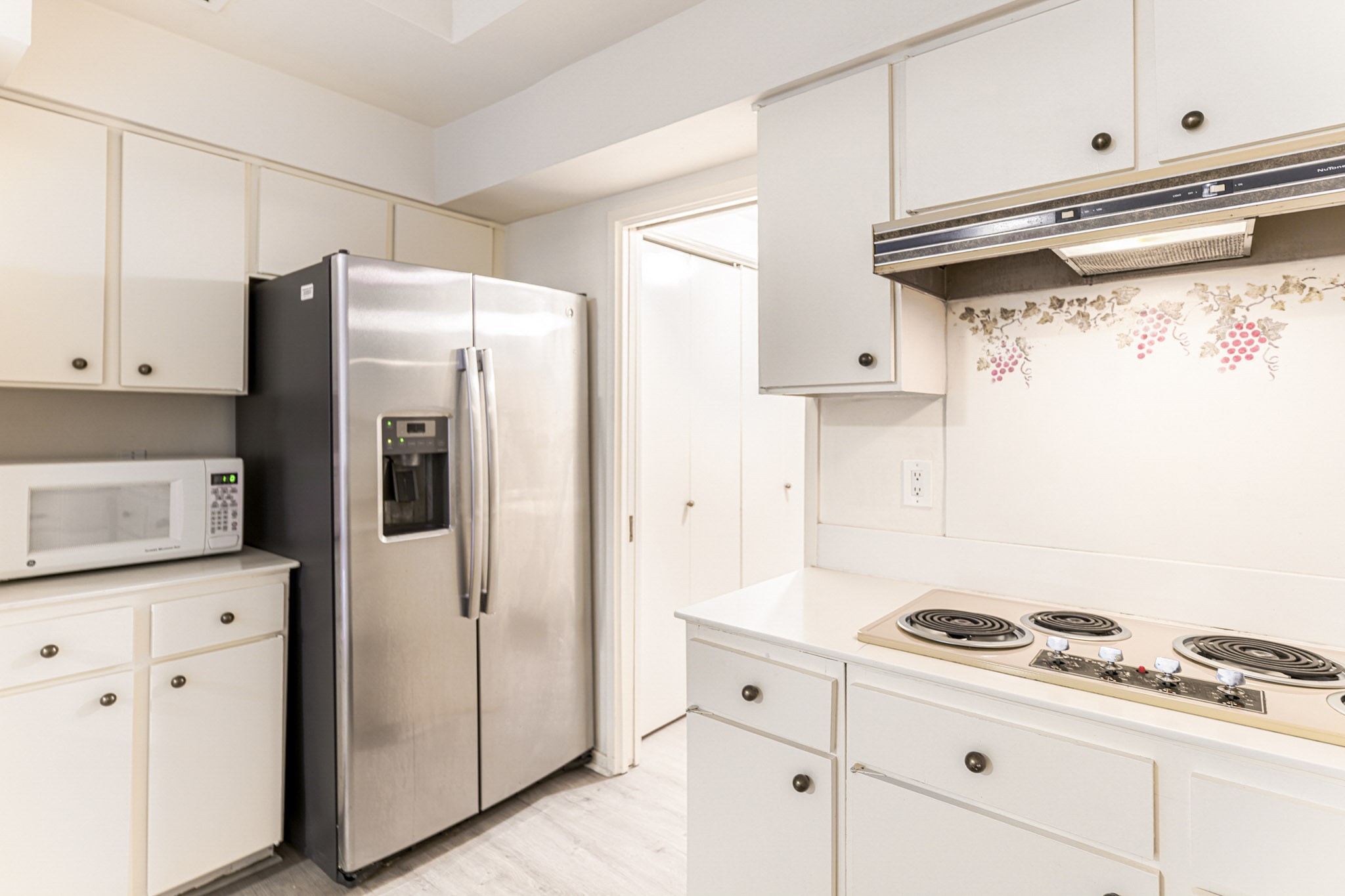 152 Litchfield Lane Houston, TX 77024 - Photo 16 of 33 a kitchen with white cabinets and white appliances