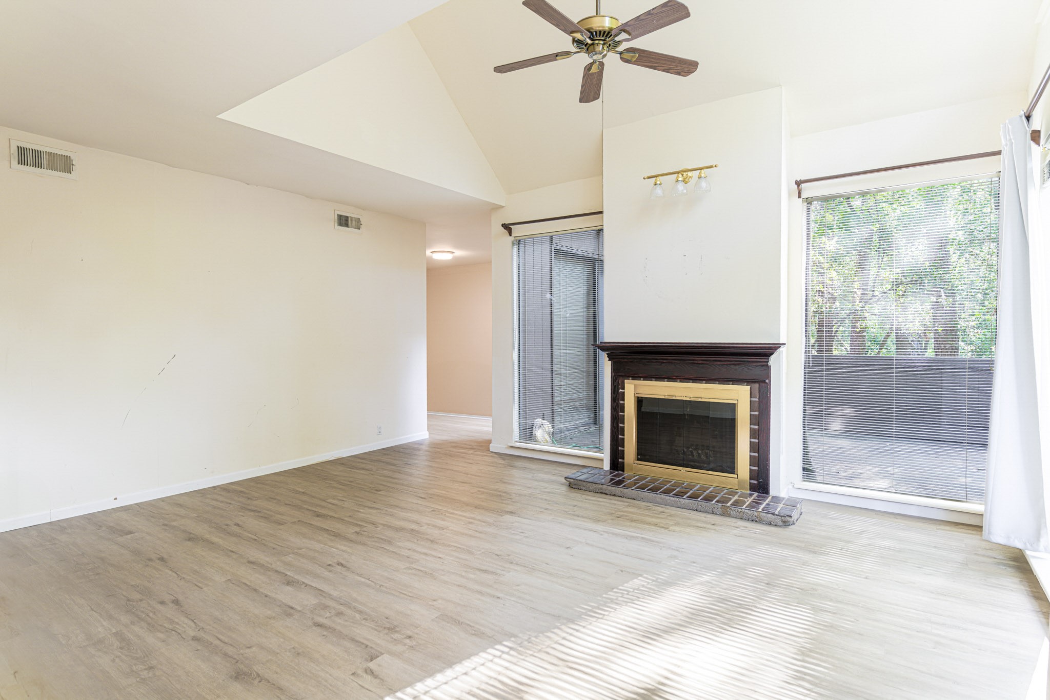 152 Litchfield Lane Houston, TX 77024 - Photo 6 of 33 a view of an empty room with a fireplace and a window