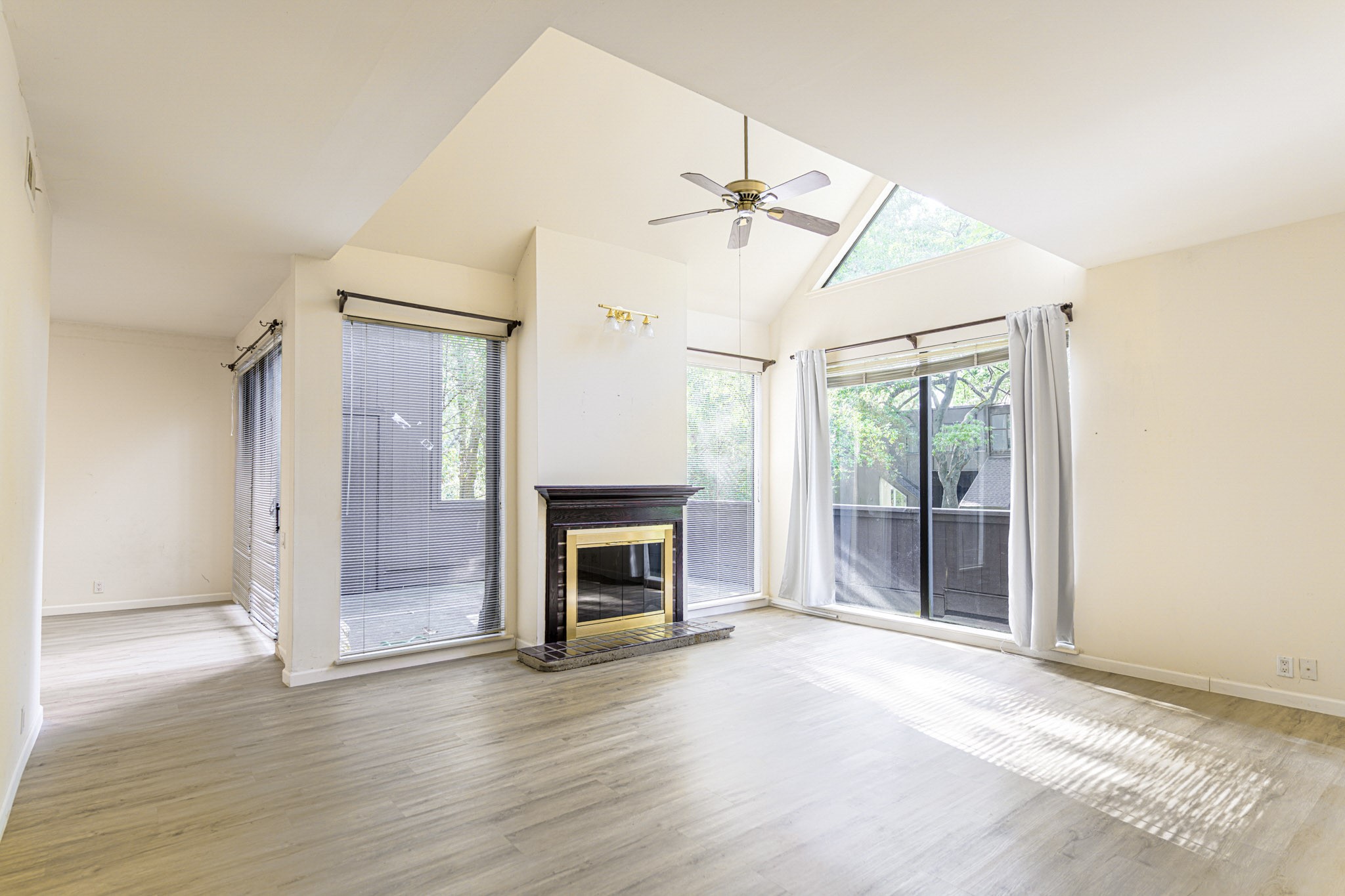 152 Litchfield Lane Houston, TX 77024 - Photo 8 of 33 a view of empty room with wooden floor and fireplace