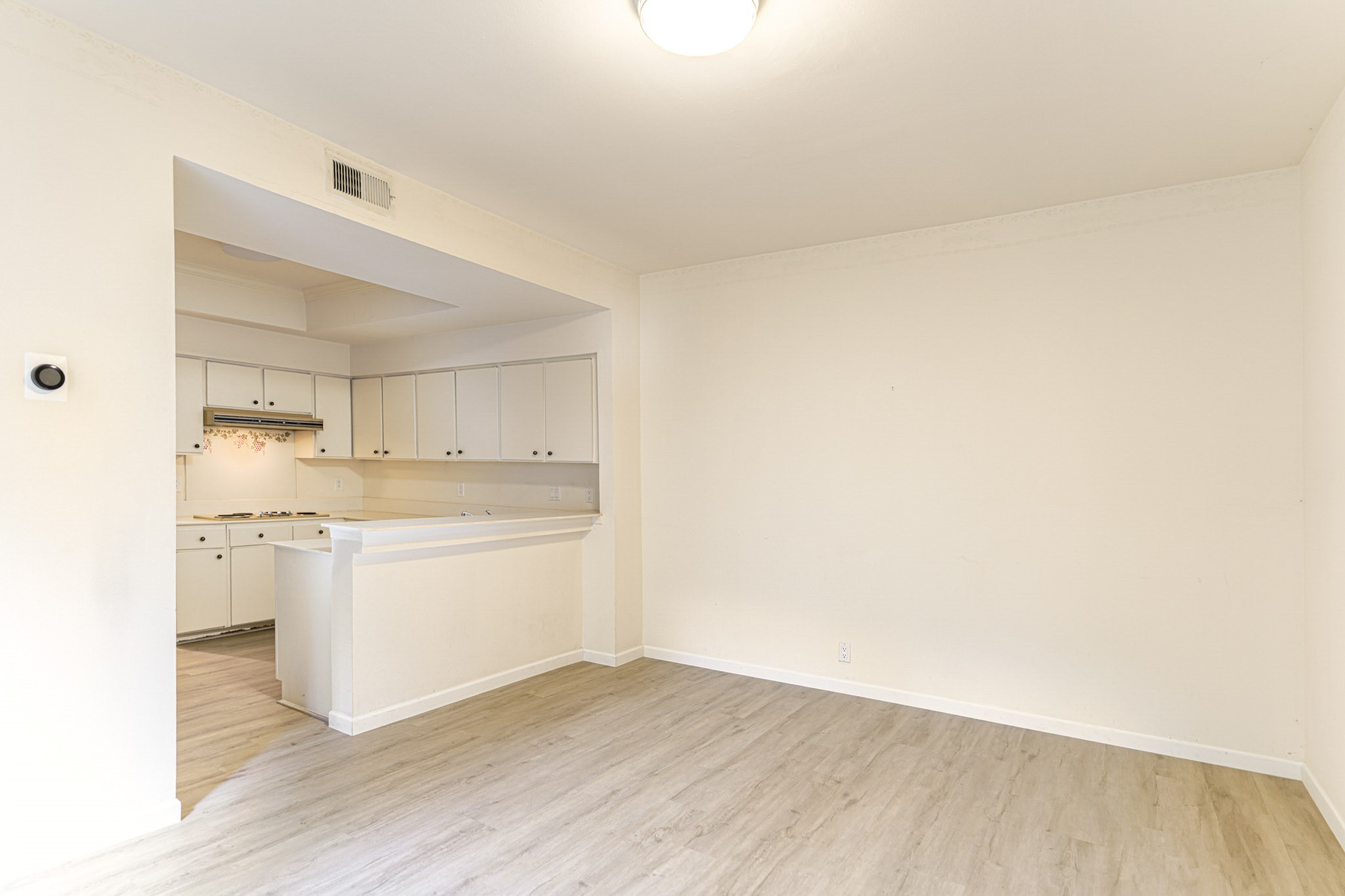 152 Litchfield Lane Houston, TX 77024 - Photo 9 of 33 a room with kitchen island a sink wooden floor and white appliances