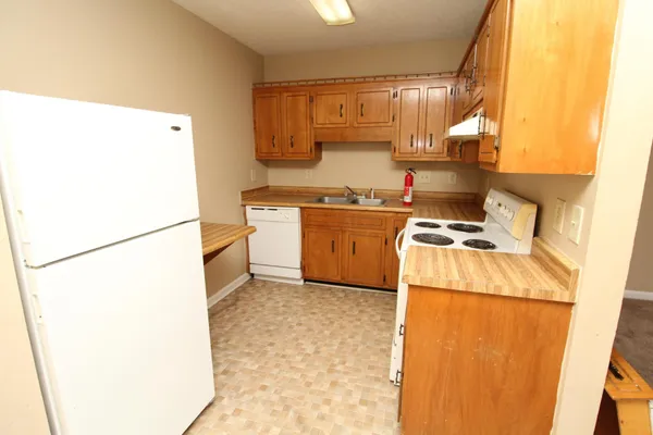 a kitchen with a sink a stove and a refrigerator