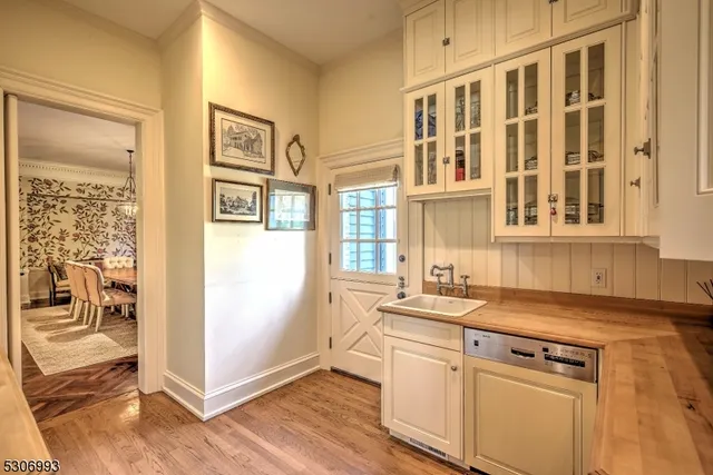 a kitchen with granite countertop a sink and a stove next to a window