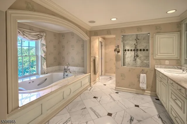 a large spacious bathroom with a tub shower and windows