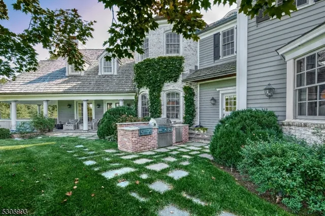 a view of a house with a backyard and a patio