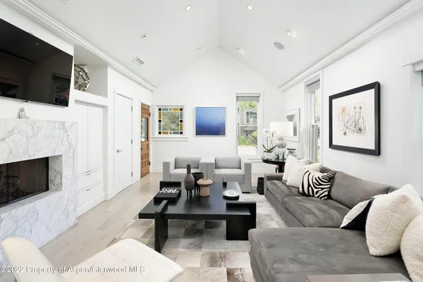 a living room with furniture a fireplace and a flat screen tv