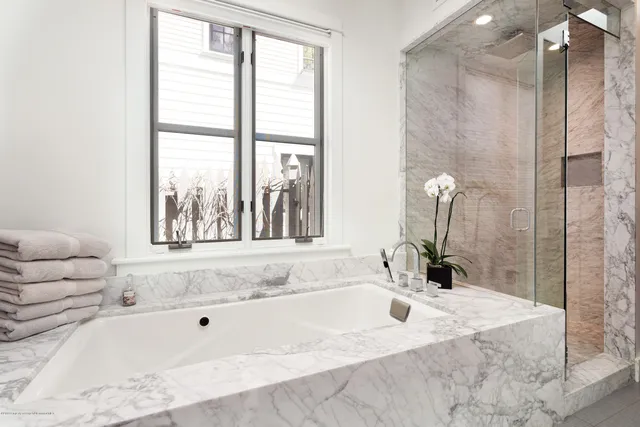a bathroom with bathtub and shower