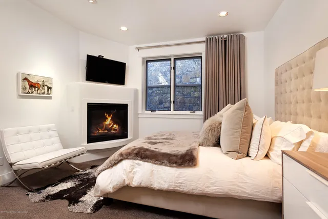 a bedroom with a bed and a fireplace