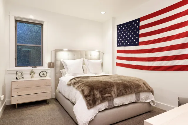 a bedroom with a bed and a night stand