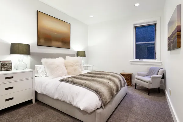 a bedroom with bed and a flat screen tv