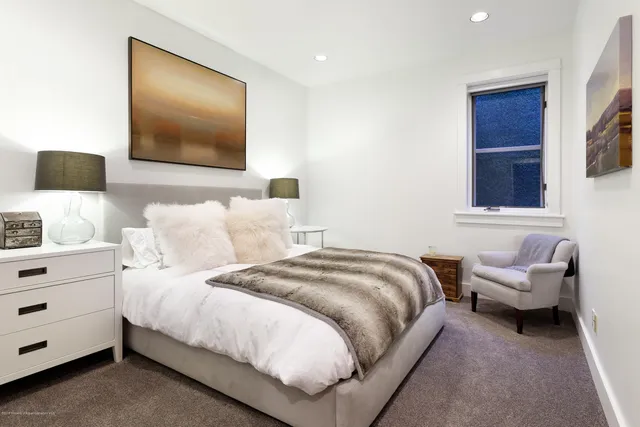 a bedroom with bed and a flat screen tv