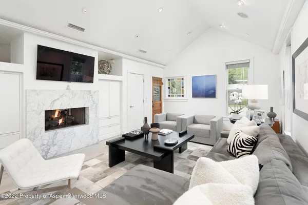 a living room with furniture fireplace and a flat screen tv