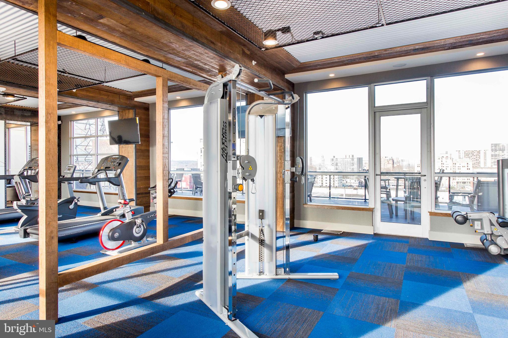 2121-41 Market Street, Unit 416 Philadelphia, PA 19103 - Photo 16 of 24 a living room with hardwood floor and large windows