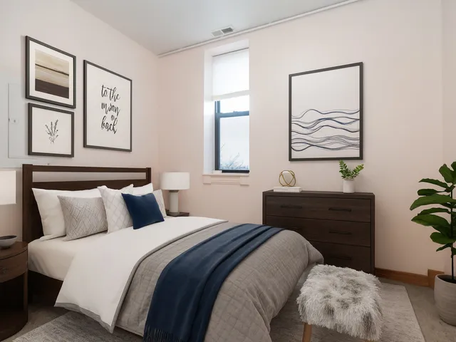 a bedroom with a bed and a painting on the wall