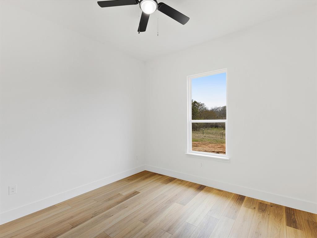 544 Shepherd Road Combine, TX 75159 - Photo 27 of 36 Spare room with light wood finished floors and ceiling fan