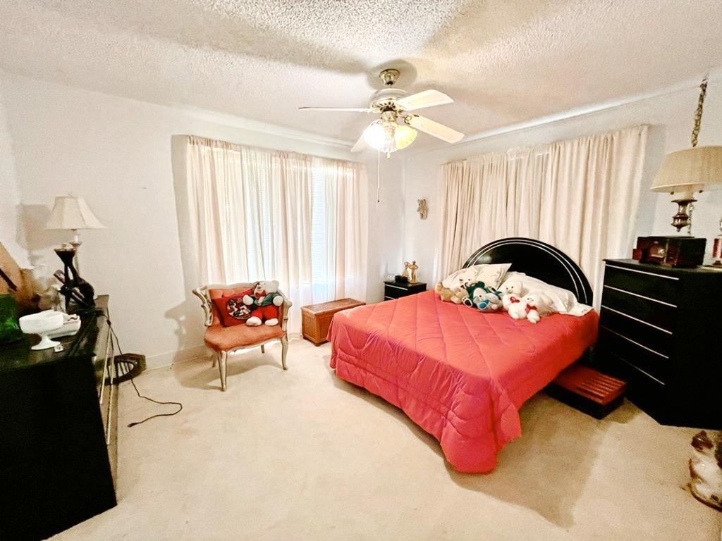 500 Chestnut Trail Forney, TX 75126 - Photo 12 of 19 a bedroom with a bed and a chandelier