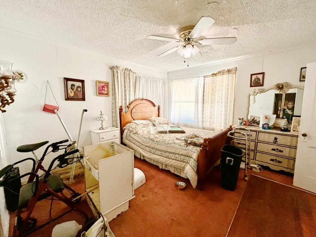 500 Chestnut Trail Forney, TX 75126 - Photo 9 of 19 a bedroom with a bed and a chandelier