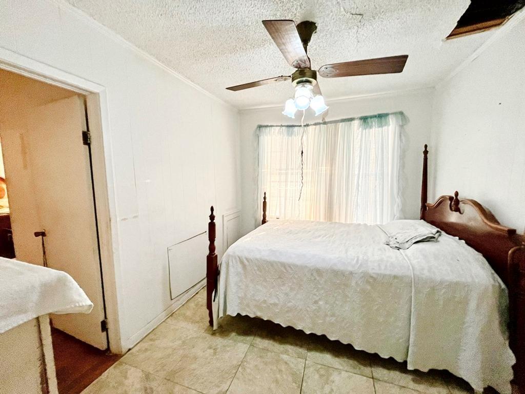 500 Chestnut Trail Forney, TX 75126 - Photo 10 of 19 a bedroom with a bed and a chandelier