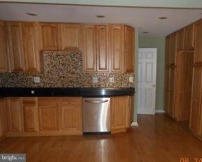 2121 Middleborough Road Baltimore, MD 21221 - Photo 5 of 10 a kitchen with stainless steel appliances wooden floor and a refrigerator
