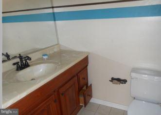 2121 Middleborough Road Baltimore, MD 21221 - Photo 8 of 10 a bathroom with a sink and mirror