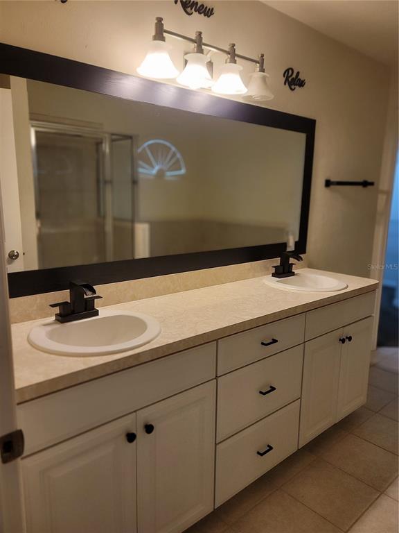 6312 Northwest 109th Place Alachua, FL 32615 - Photo 11 of 17 a bathroom with a sink and a mirror
