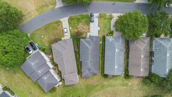 an aerial view of multiple houses with yard