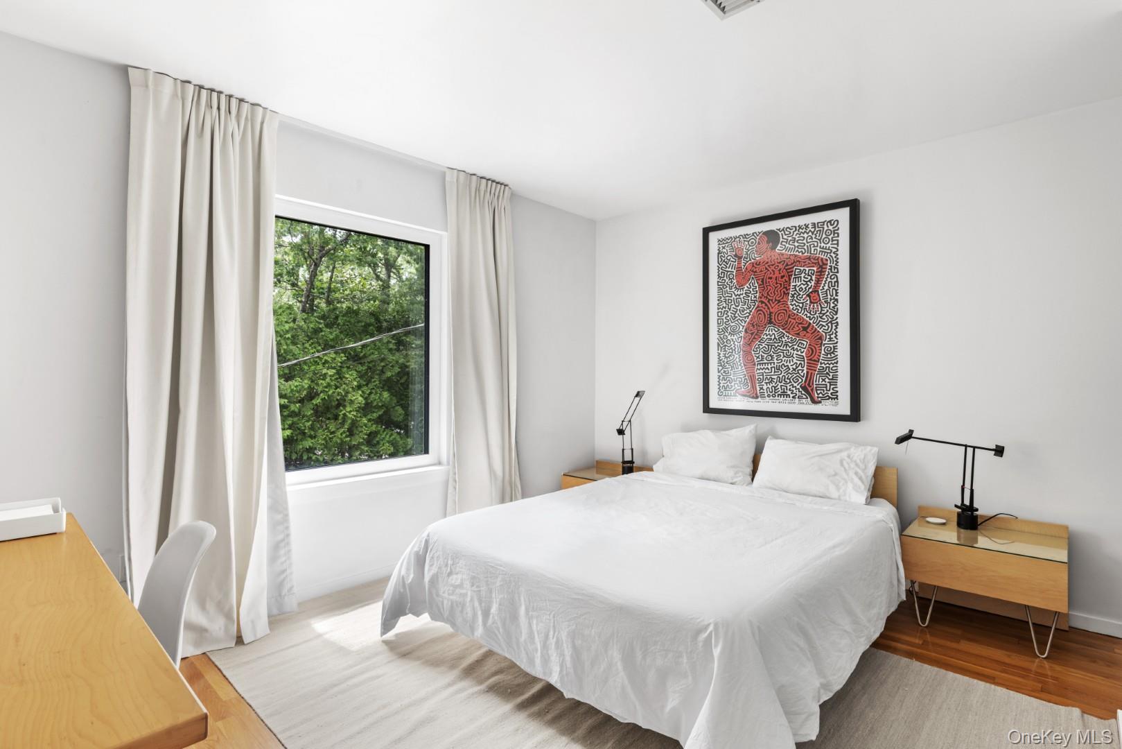 24 Quogue Riverhead Road Quogue, NY 11959 - Photo 11 of 22 a bedroom with a bed and a large window
