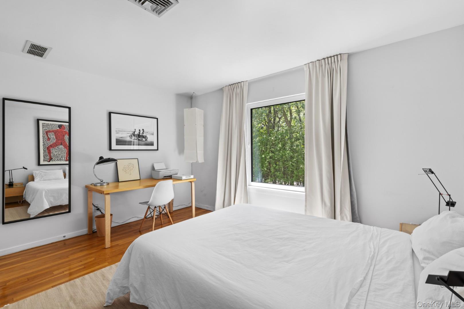 24 Quogue Riverhead Road Quogue, NY 11959 - Photo 12 of 22 a bedroom with a bed and wooden floor