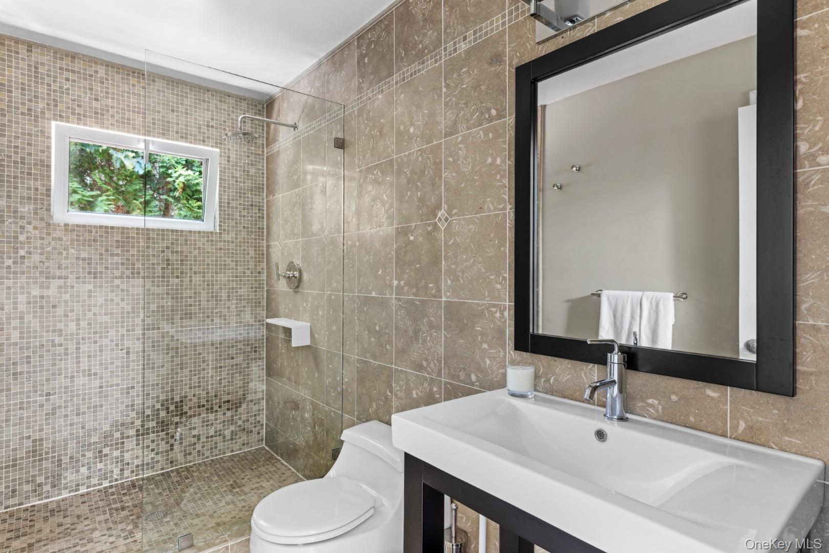 24 Quogue Riverhead Road Quogue, NY 11959 - Photo 13 of 22 a bathroom with a sink a toilet and shower