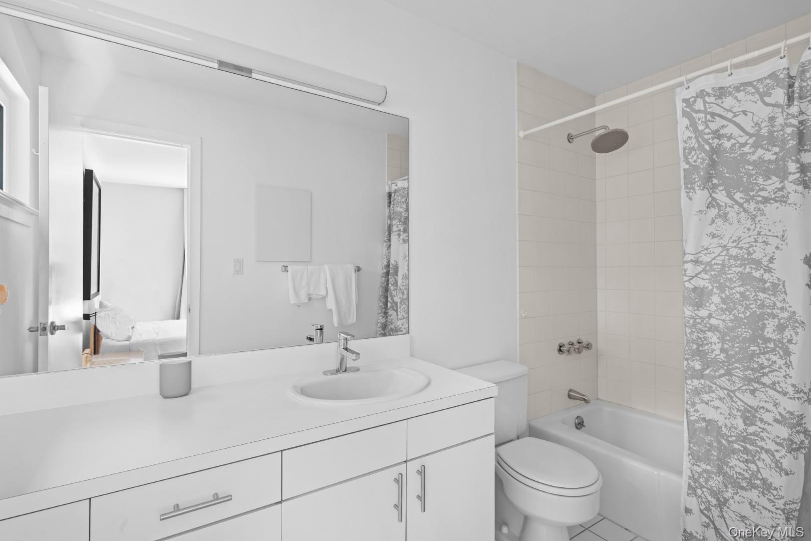 24 Quogue Riverhead Road Quogue, NY 11959 - Photo 15 of 22 a bathroom with a sink toilet a mirror and shower
