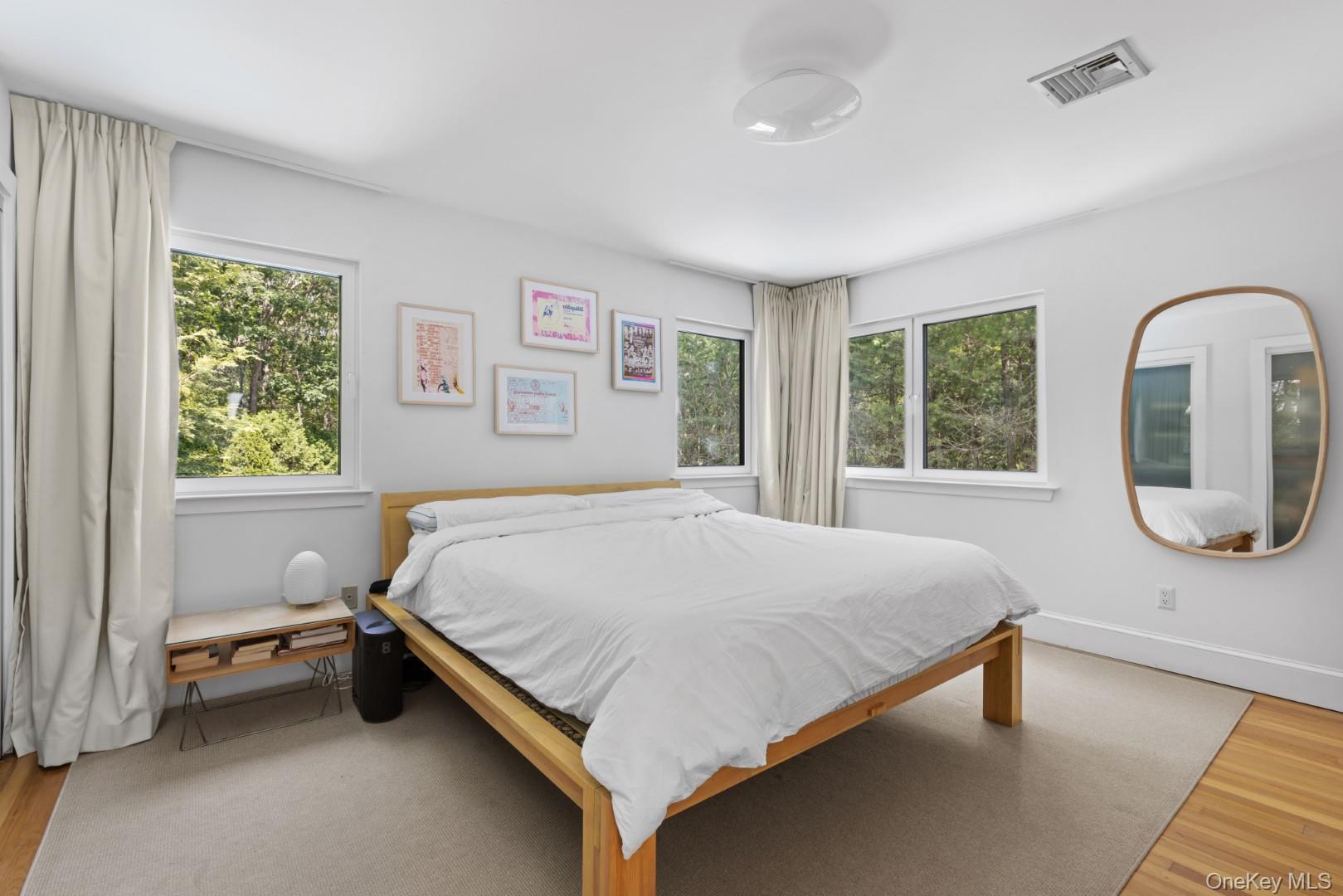 24 Quogue Riverhead Road Quogue, NY 11959 - Photo 16 of 22 a bed sitting in a bedroom next to a window
