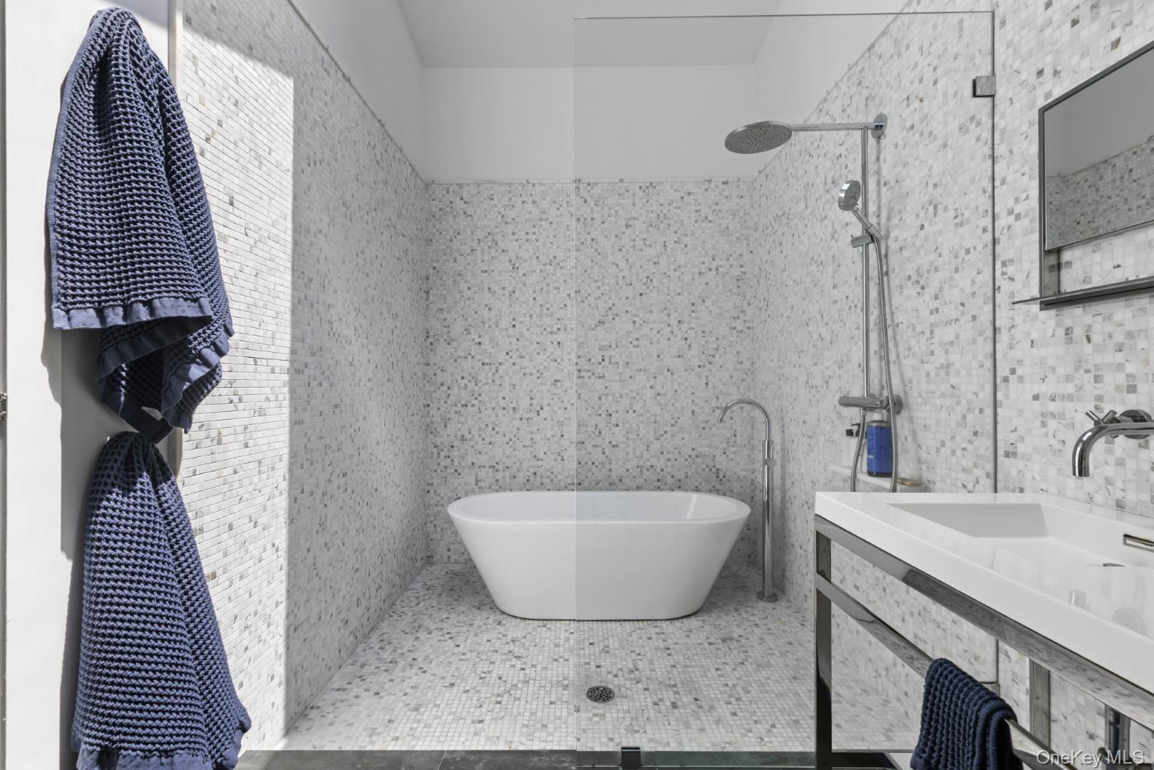 24 Quogue Riverhead Road Quogue, NY 11959 - Photo 18 of 22 a bathroom with a sink and a mirror