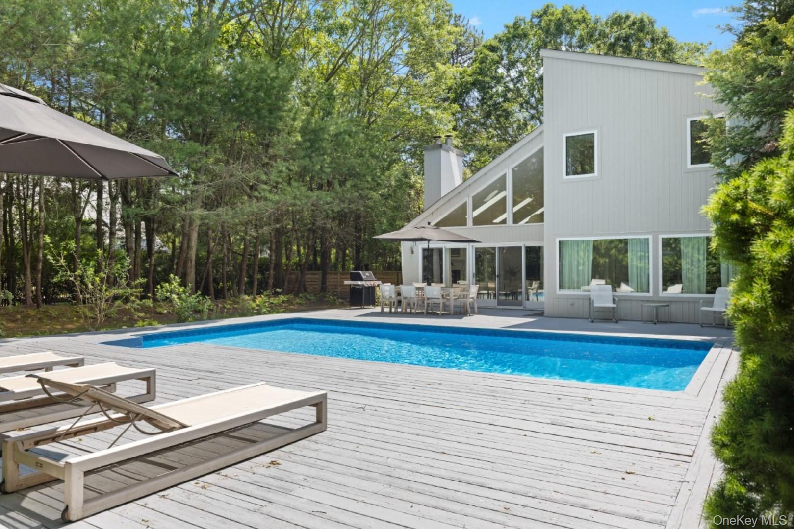 24 Quogue Riverhead Road Quogue, NY 11959 - Photo 19 of 22 a front view of house with yard and outdoor seating
