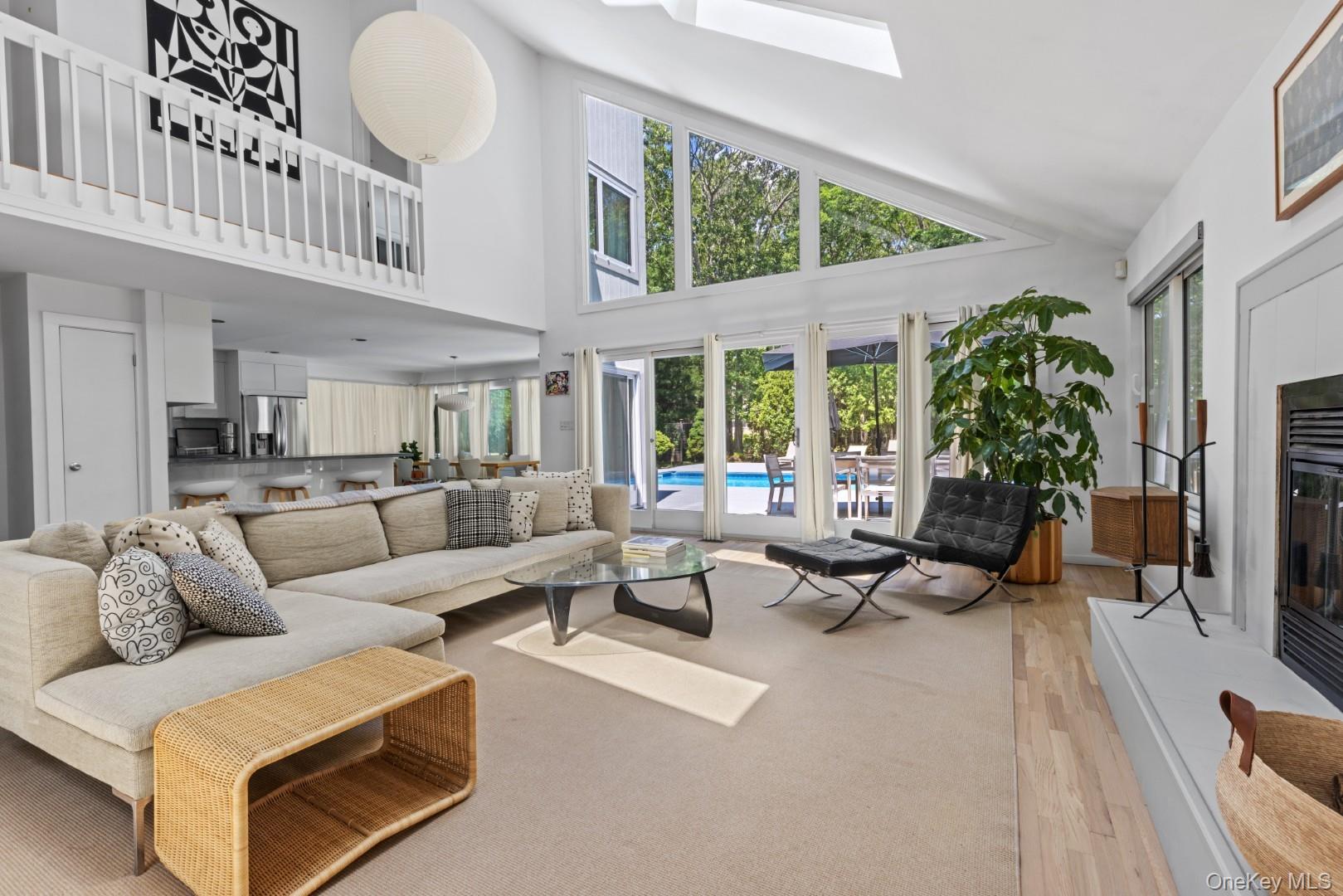 24 Quogue Riverhead Road Quogue, NY 11959 - Photo 2 of 22 a living room with furniture kitchen view and large windows