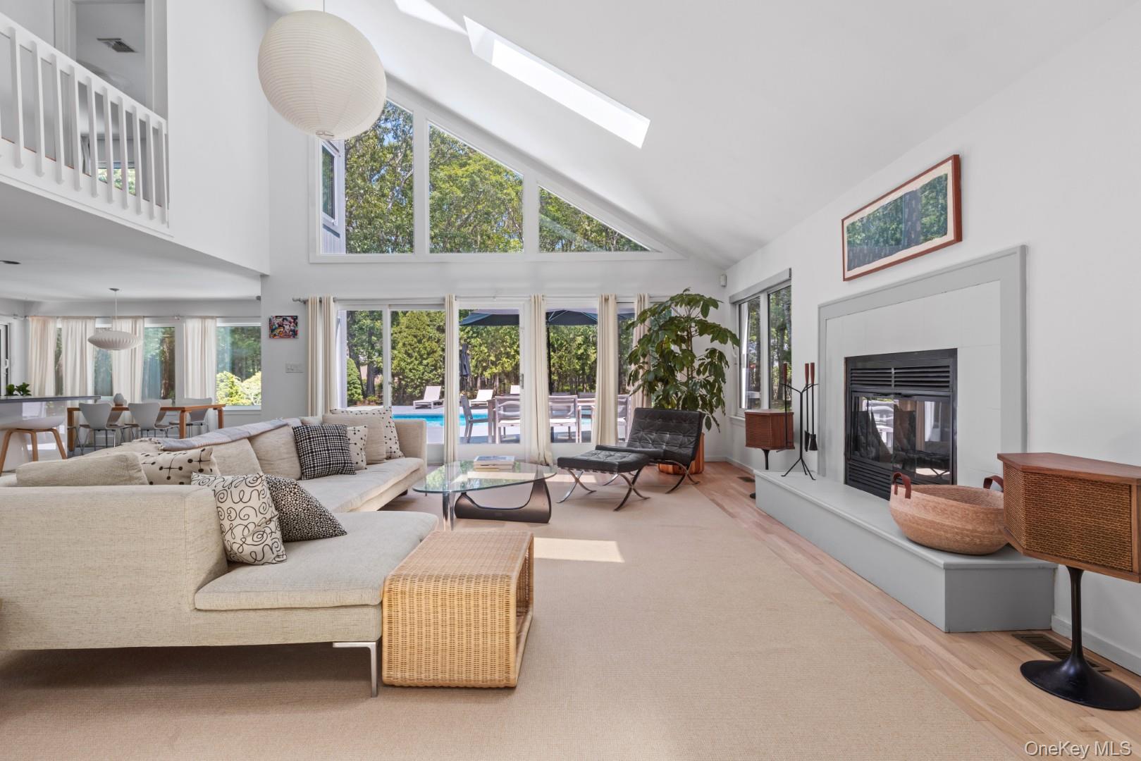 24 Quogue Riverhead Road Quogue, NY 11959 - Photo 3 of 22 a living room with furniture and a fireplace