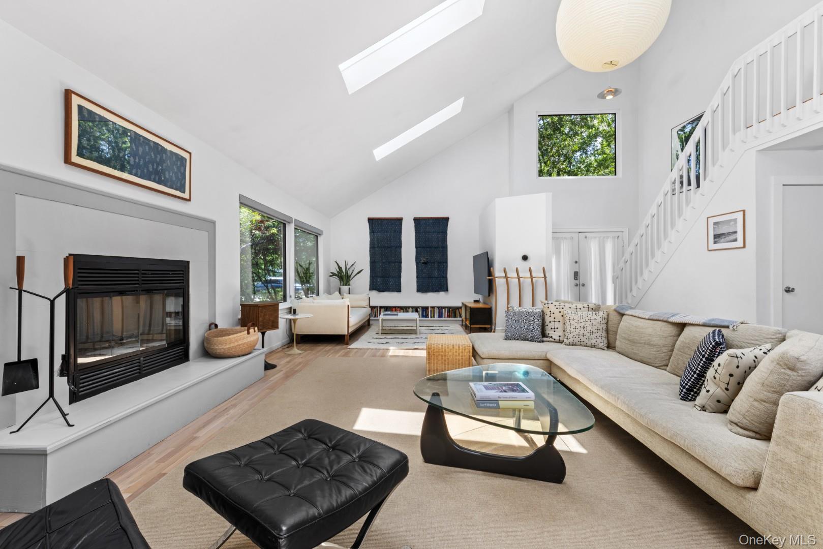 24 Quogue Riverhead Road Quogue, NY 11959 - Photo 5 of 22 a living room with furniture and a fireplace